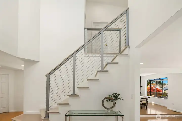 The soaring modern staircase is an intentional design feature of the home.
