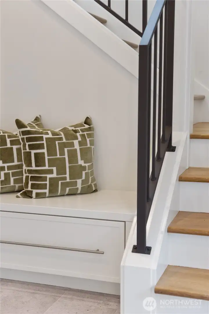 A custom cabinet with drawer for storage at the foot of the stair. A custom cabinet with drawer for storage at the foot of the stair.