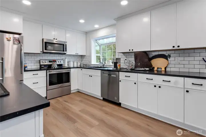 Large updated kitchen with new appliances and tile backsplash. Large updated kitchen with new appliances and tile backsplash.