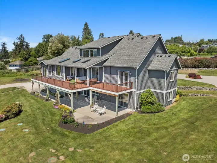 Backside of the main house featuring recently replaced skylights, large back deck on the upper level and spacious patio on the lower level. Backside of the main house featuring recently replaced skylights, large back deck on the upper level and spacious patio on the lower level.