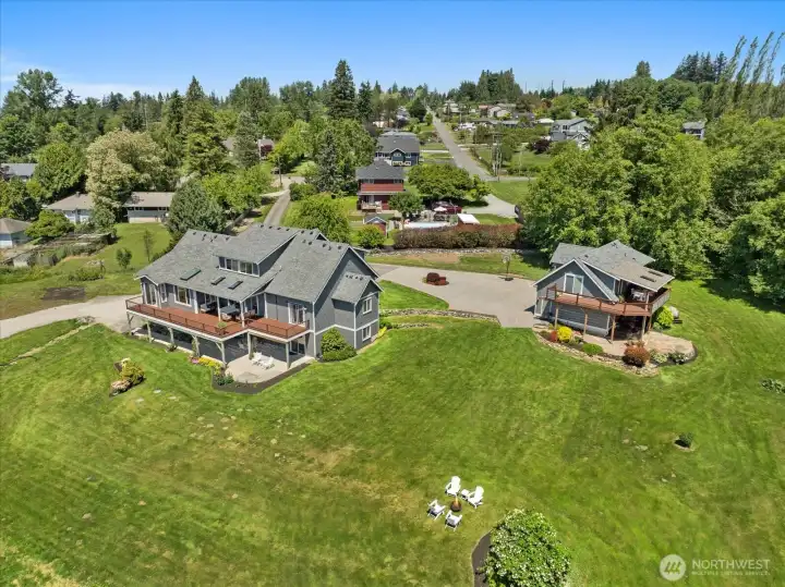 Aerial view of the main house and garage/office with expansive backyard. Aerial view of the main house and garage/office with expansive backyard.