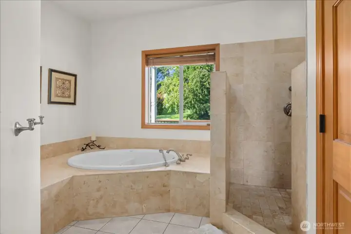 Primary suite bathroom with soaking tub and standing shower. Primary suite bathroom with soaking tub and standing shower.