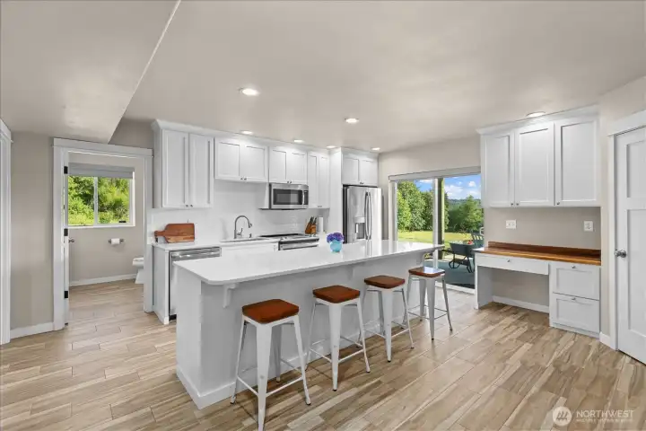 Kitchen with large island and bar top seating. Kitchen with large island and bar top seating.