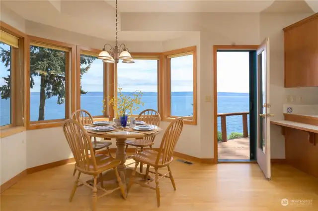 Sweet breakfast room with fabulous views of Sound and Mtns. Deck access to wide almost full length deck. Your favorite beverage here and listen to all the marine life on the Sound.
