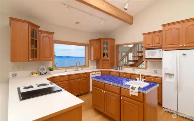 Another view of the lovely bright kitchen with so much cabinet space!