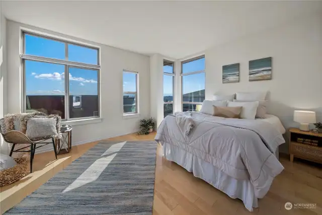 Luxurious primary suite has breathtaking views of the city and mountains.