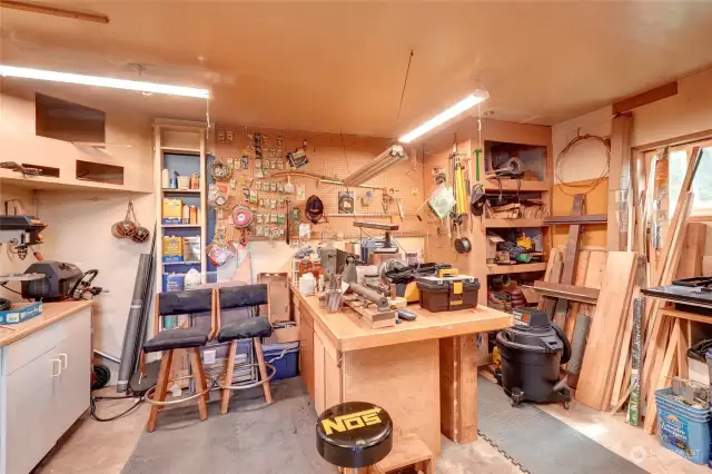 This shop is the envy of all who dream of place for big projects! Several workbenches and many shelves and cubbies for storage. There is a sink with hot & cold water.