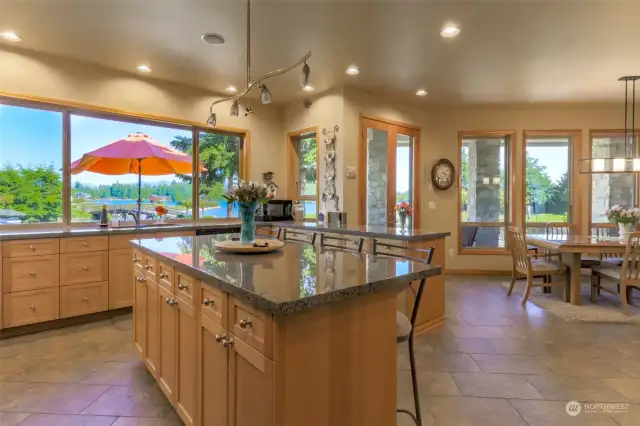 Huge kitchen area with large island, all granite countertops.