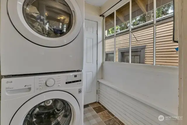 Laundry area with stacking washer and dryer.