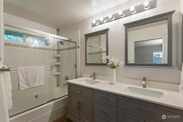 Updated primary bathroom with dual sinks, shower & tub