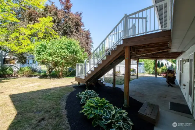 Stairs from upper trex deck to yard and patio area