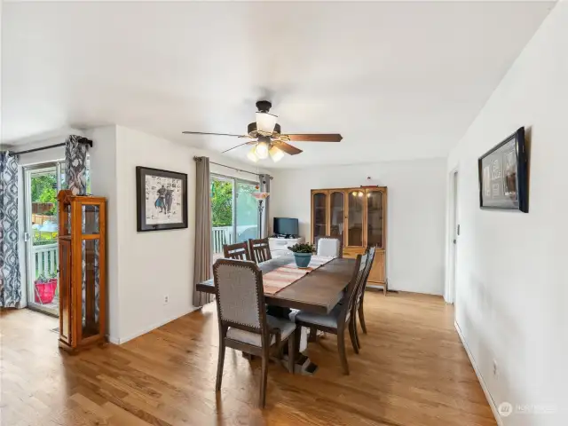 Spacious dining room with sliding door leading to large deck overlooking the lovely yard.