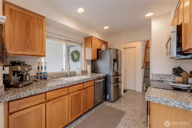 Elegant granite-tiled countertops complemented by classic Shaker-style cabinetry