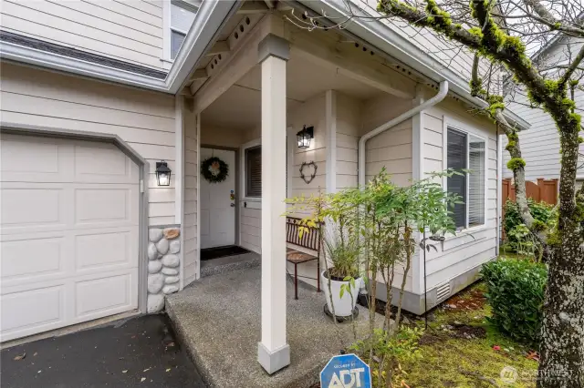 The inviting front door opens to a warm and welcoming entryway, setting the tone for the rest of this beautifully designed home
