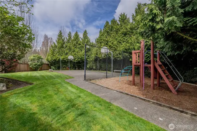 Beautifully landscaped grounds with mature trees and a dedicated playground area