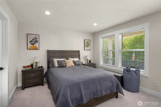 Primary bedroom with private deck with views of Puget Park and walk-in closets and en suite.
