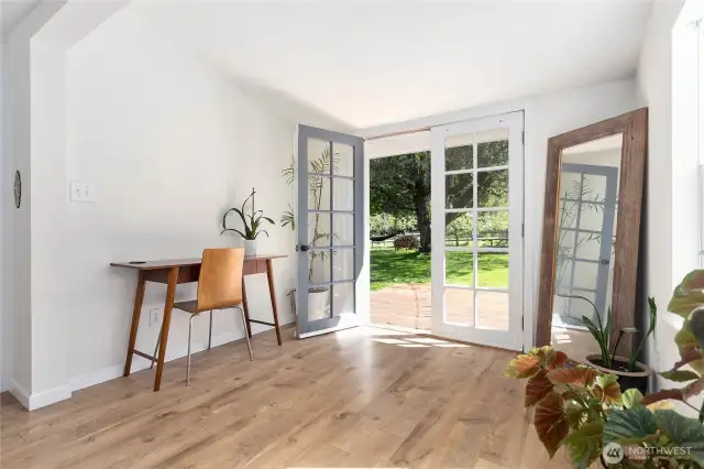 Primary bedroom. View looking out of french doors into the back yard.