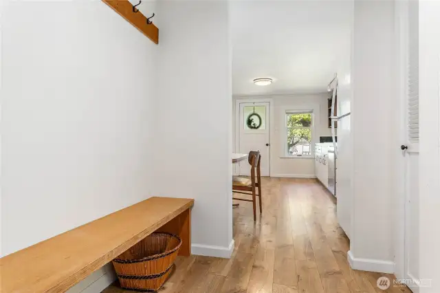Hall way with bench and coat rack.
