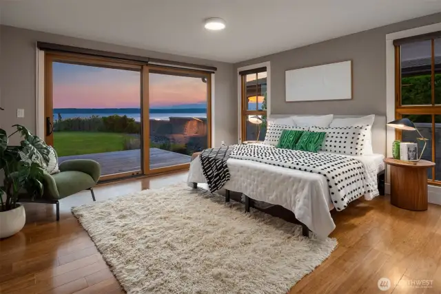 Primary bedroom steps to back deck, across lawn and onto the shores of Puget Sound.