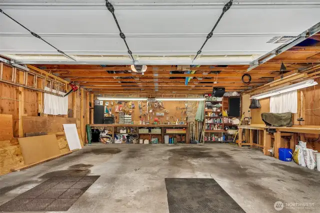 Huge detached 2 car garage with work bench and storage in the rafters