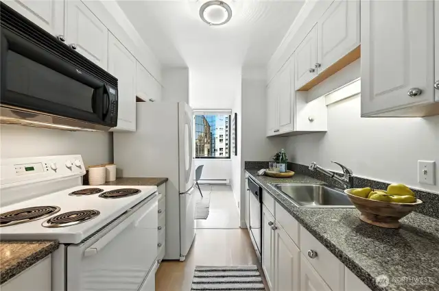Lovely updated white kitchen with great counter & cabinet storage space.