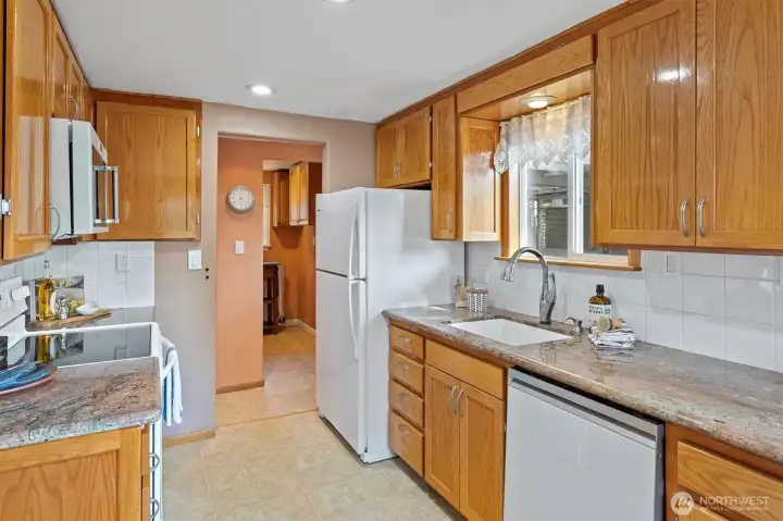 The open galley kitchen features a window over the seat . . .