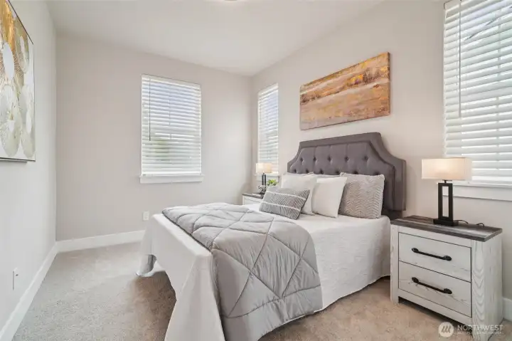 Photos of the staged model home with the same floorplan and similar finishes.