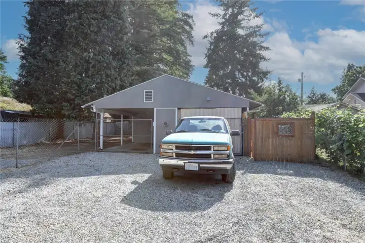 Parking at the end of the building. The fence is the gated entrance to the front of the building
