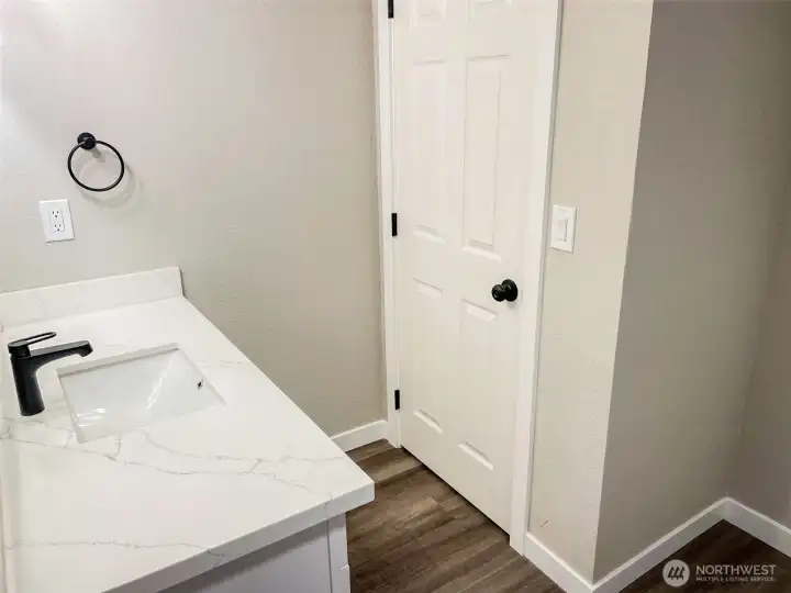 DOWNSTAIRS BATH...COMMODE BEHIND DOOR