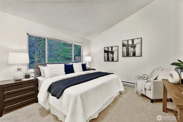 Second upstairs bedroom, spacious with a treehouse feel looking out at the forest!