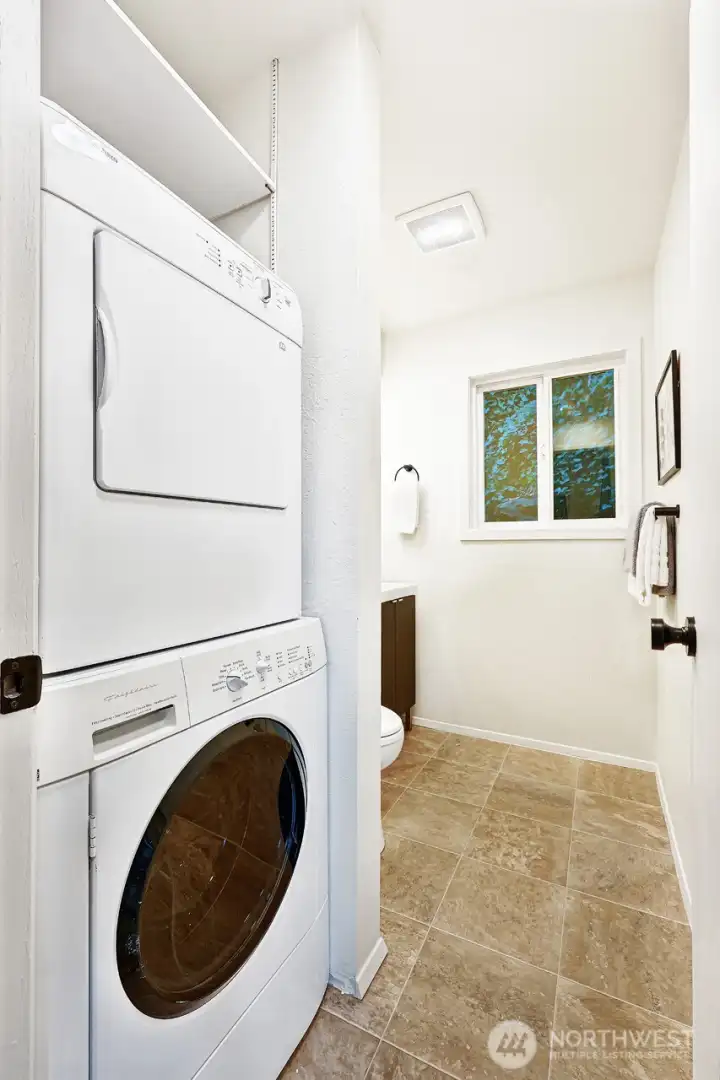 Half bathroom and laundry room on the main level great for guests - washer and dryer are included in the sale.