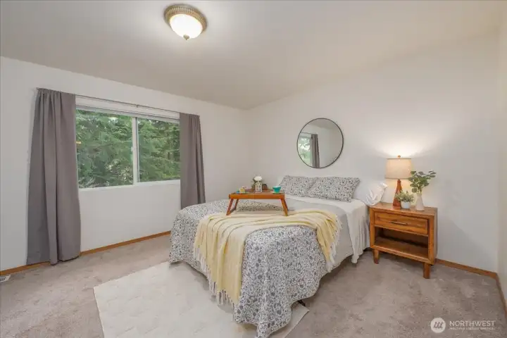 Main bedroom is filled with warm light and so spacious.  Trees provide privacy and nature garden.
