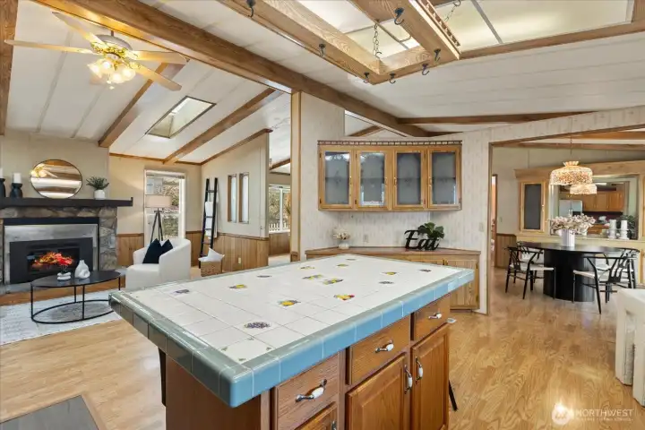 Kitchen opens to the second living area with gas fireplace.