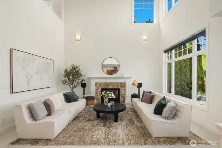 Expansive windows and soaring ceilings bathe the home with natural light.