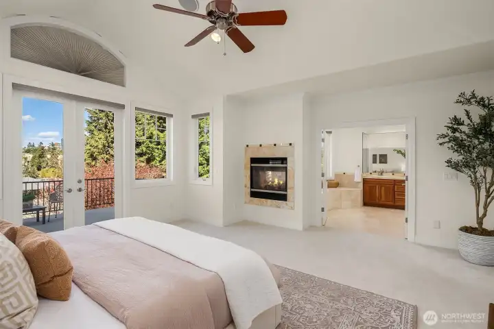 The primary suite is completed with a cozy fireplace, walk-in closet, spa-style bath, and private deck.