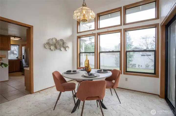 Dining room with gorgeous windows and lighting, very tall ceilings