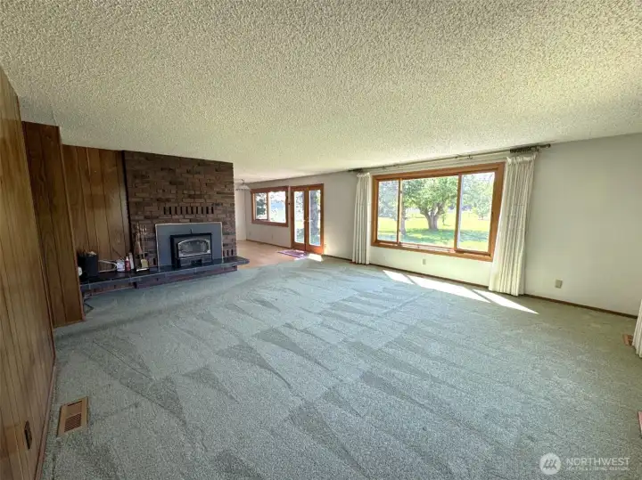 Living, toward the backdoor, and dining nook, wood stove insert heats the home very nicely in the winter.