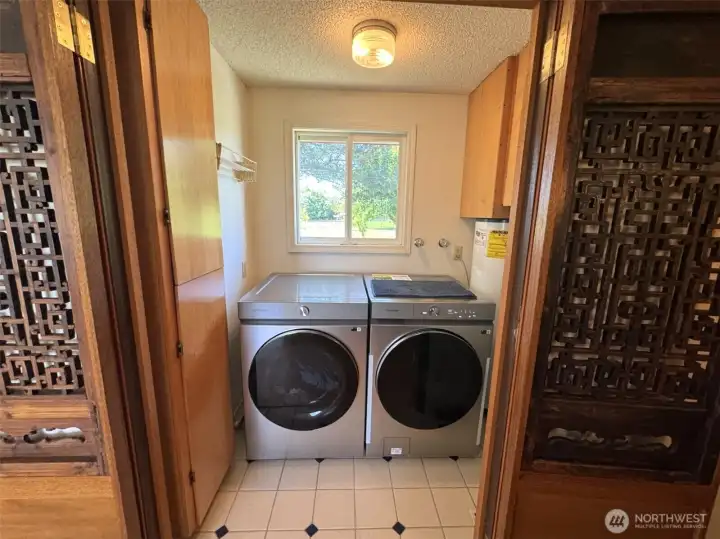 Laundry--water tank and well tank are to the right of the washer.  There is a capped gas connection if a gas dryer is preferred.