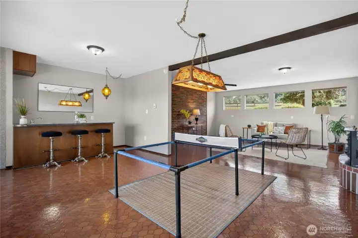 The lower rec room has space for a large game table. The lower rec room has space for a large game table.
