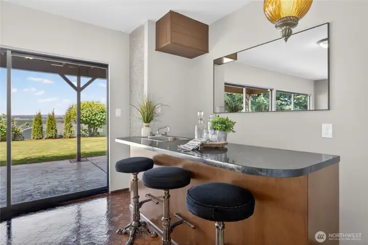 Lower rec room features a wet bar and opens up to the lower patio. Lower rec room features a wet bar and opens up to the lower patio.