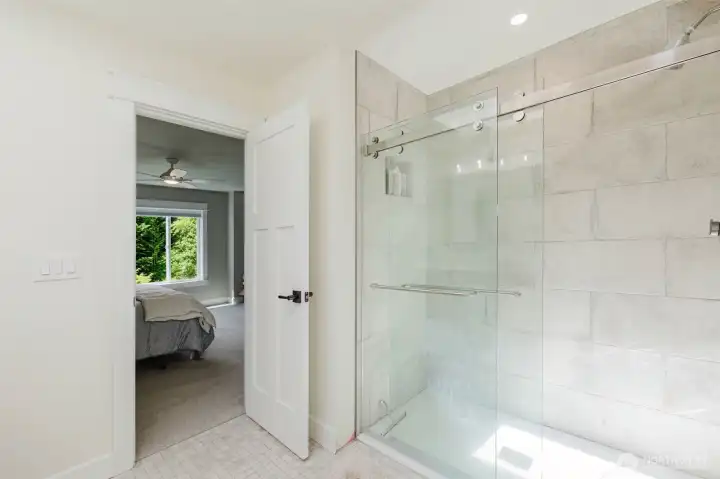 Bedroom #3, walk-in shower appointed with Italian ceramic tile.