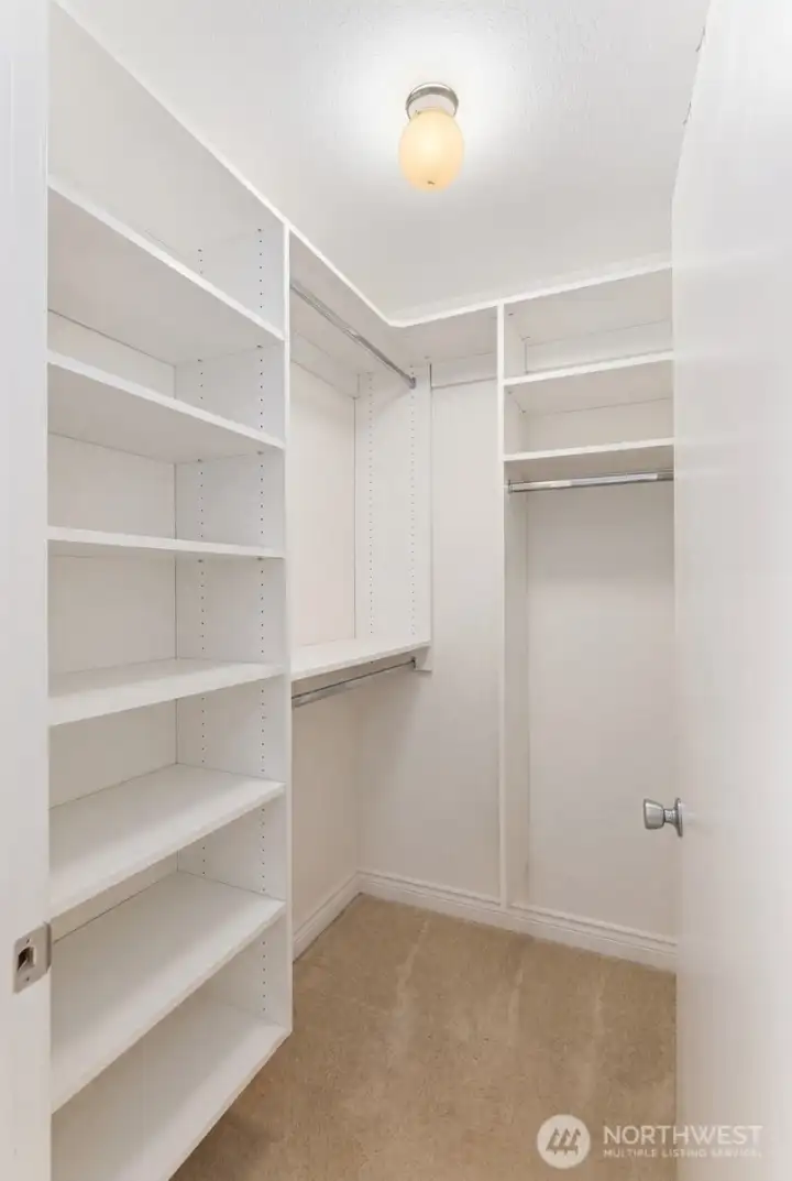 Primary bedroom walk-in closet Primary bedroom walk-in closet