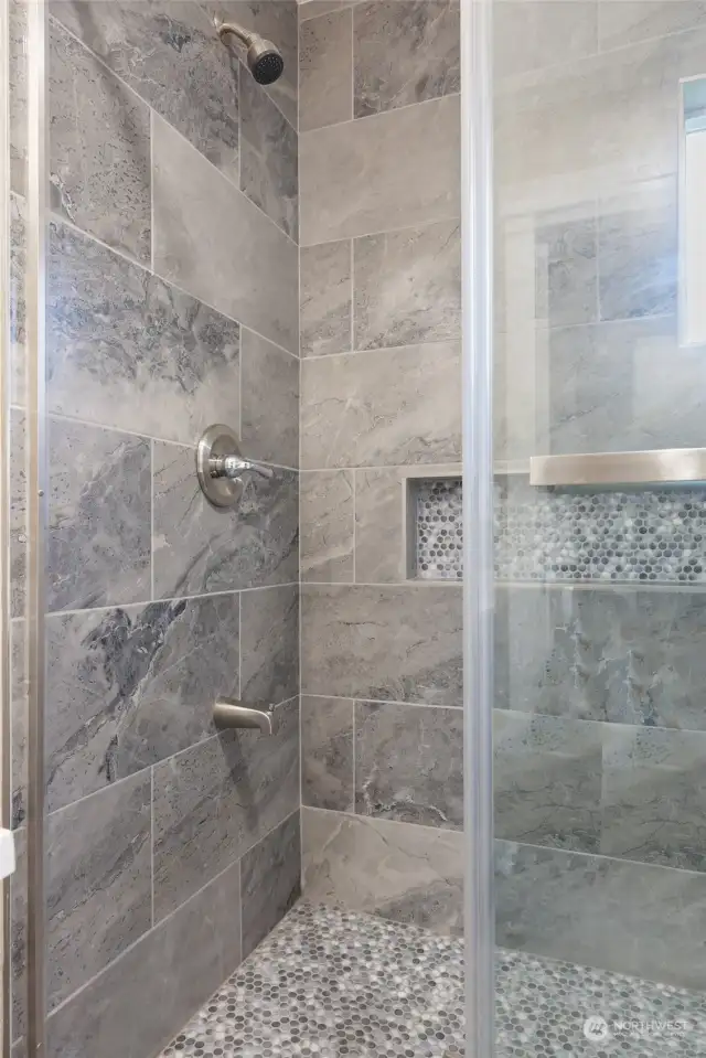 New renovated bath with new glass door, Quartz countertops and MOSAIC accent tiles elevate the bathrooms' elegance.