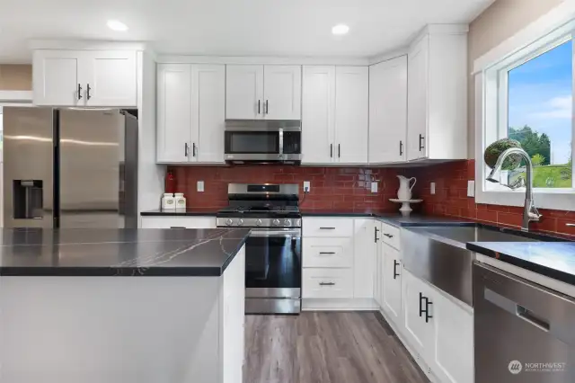 The heart of this home lies in its kitchen, where new custom-built cabinets, Quartz countertops, and a tile backsplash complement stainless steel appliances and a gas range. The Single Basin SS kitchen sink adds both functionality and elegance to the space, making it a chef's dream.
