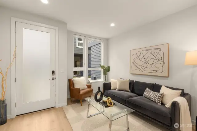 Relax in this bright, airy living room, where large windows bring abundant natural light.