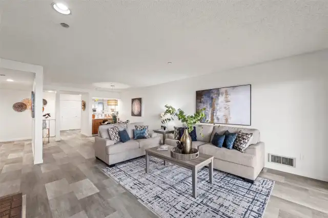 The open living room flows effortlessly from the dining area, creating a spacious and connected feel that's perfect for both relaxing and entertaining.