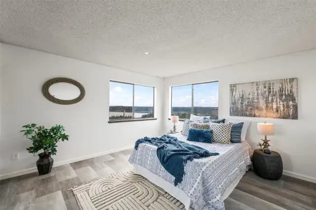 Wake up to expansive water views from the primary bedroom. Large windows fill the room with natural light and provide an ever-changing backdrop of the Sound.