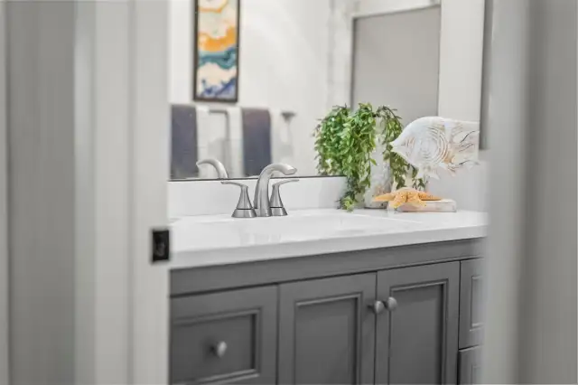 The secondary bathroom is equally refreshed with updated lighting, new vanity, and contemporary tile finishes — perfect for guests or everyday use.