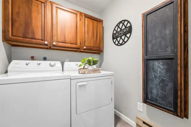 The dedicated laundry room includes a full-size washer and dryer, plus ample storage. Practical and convenient.