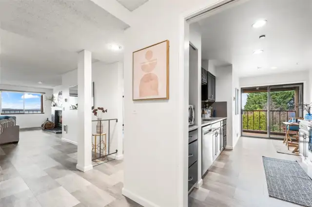 As you move through, the open flow draws you toward the kitchen and living areas, where natural light and stunning water views create a sense of calm and comfort. It’s easy to picture yourself here—organized, relaxed, and right at home.